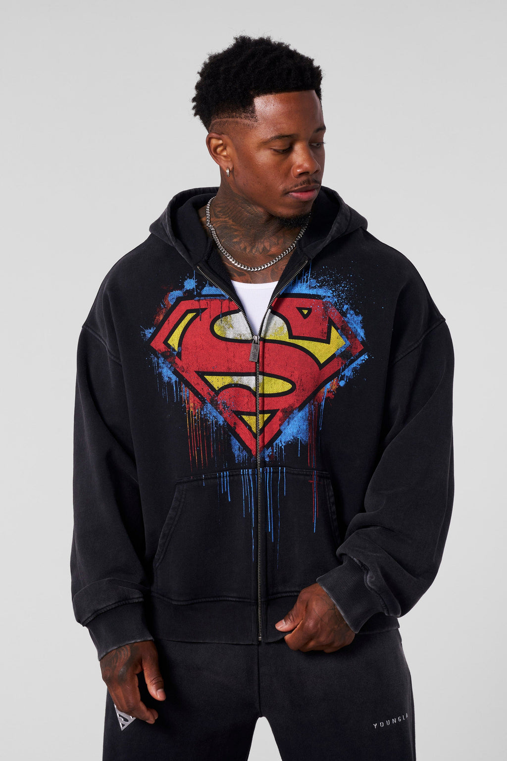 5011 - Superman Drip Zip-Ups - Hoodie iwith a bold paint-style Superman logo on the front, combining streetwear and superhero style in Black Wash.