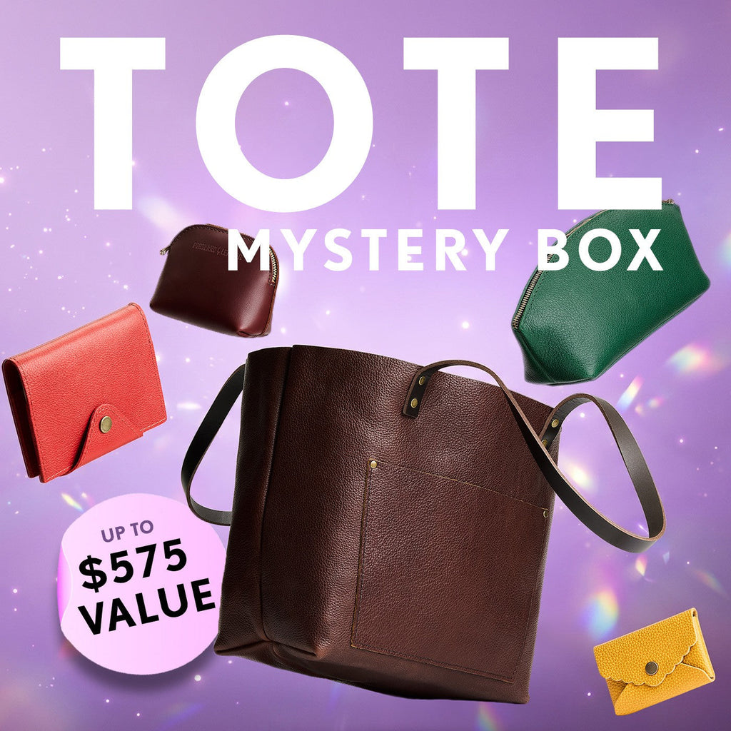 Promotional graphic for a 'Tote Mystery Box' featuring a collection of totes, wallets, and small goods. Set against a purple sparkly background with a pink badge indicating up to $575 value.