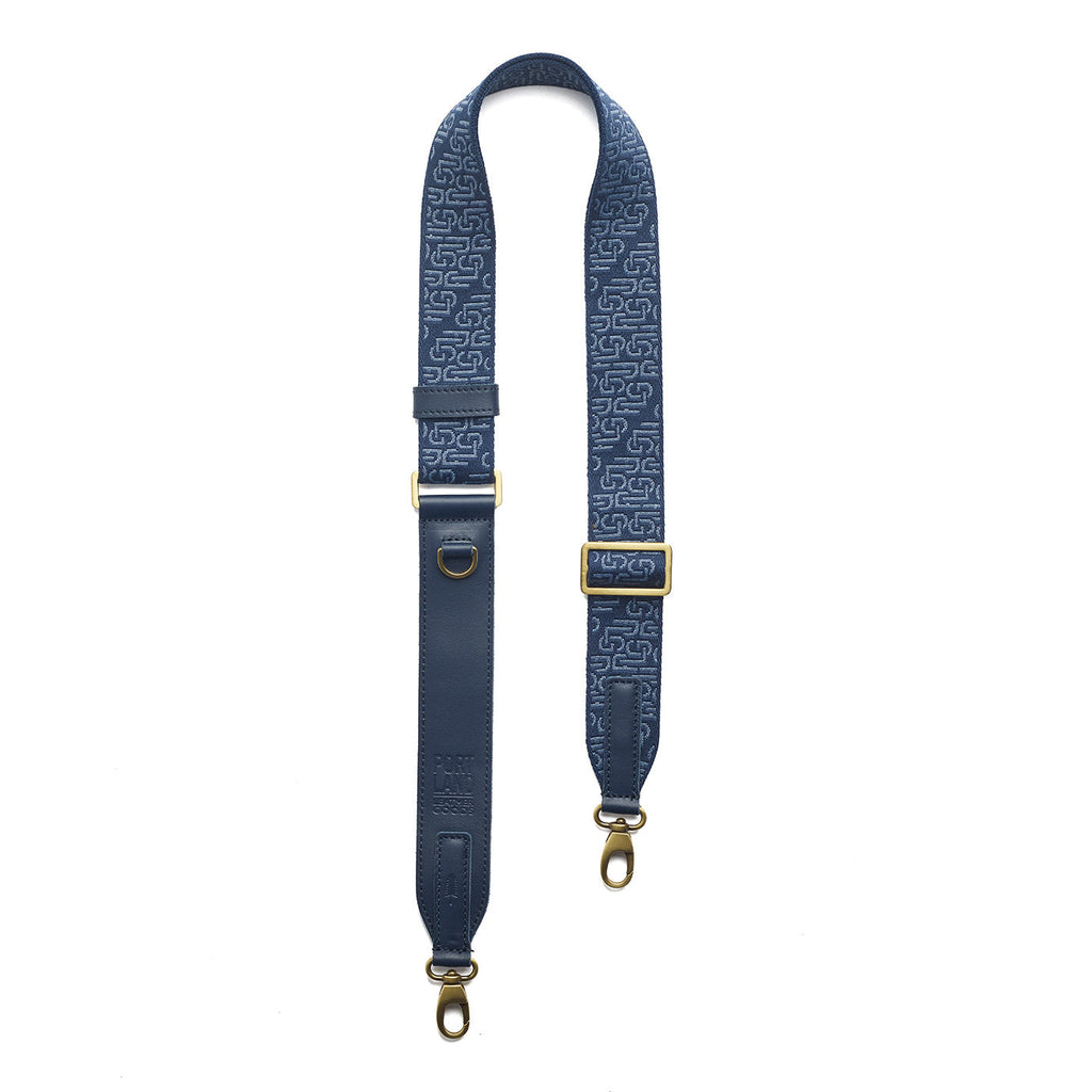 Arctic Depth | Leather and webbing strap with repeating PLG lettering on a white background
