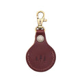 Cognac | Round leather AirTag holder with snap closure and swivel lobster claw clasp